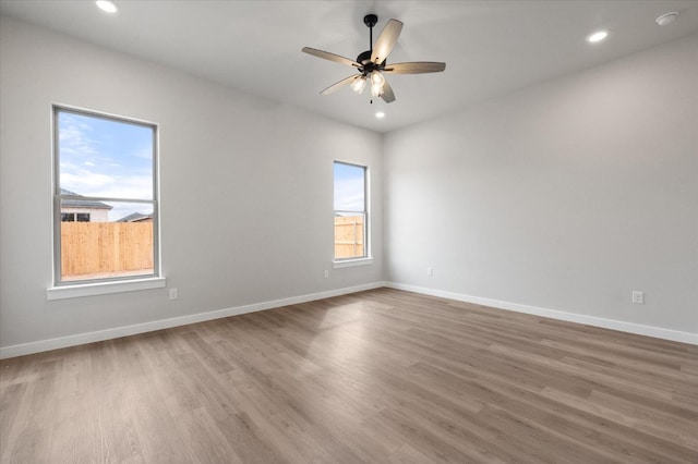 unfurnished room with wood-type flooring and ceiling fan