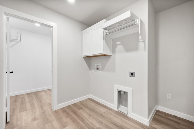 laundry area with cabinets, hookup for a washing machine, hookup for an electric dryer, and light hardwood / wood-style flooring