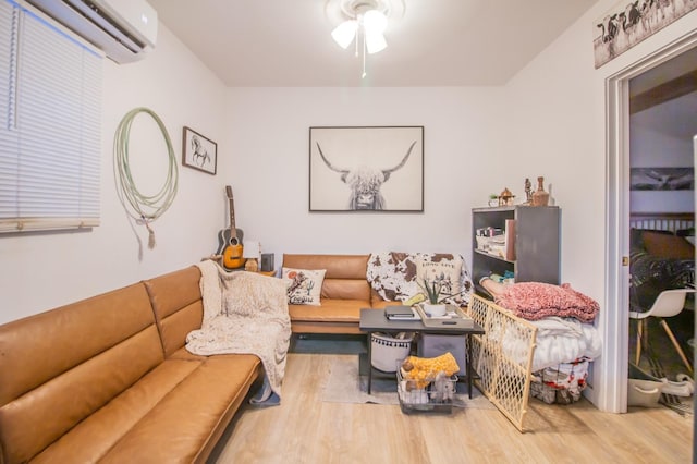 living room featuring ceiling fan, wood-type flooring, and a wall unit AC