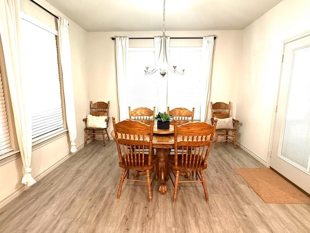 dining area featuring a notable chandelier and light hardwood / wood-style flooring