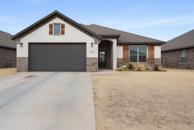 view of front of house featuring cooling unit and a garage