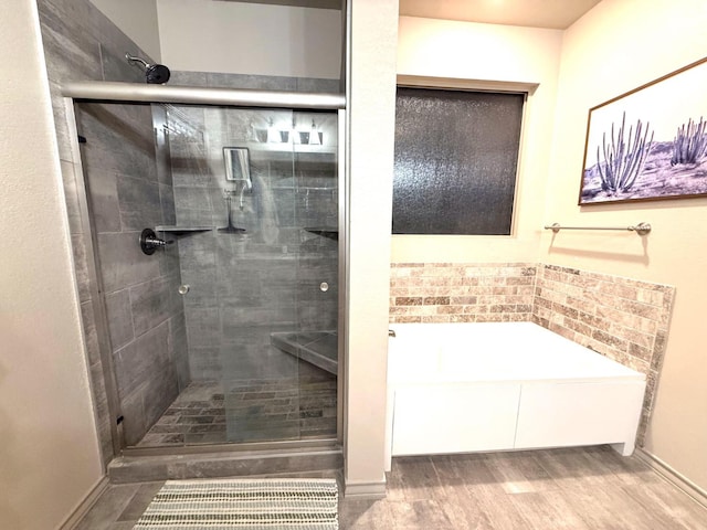 bathroom with wood-type flooring and plus walk in shower