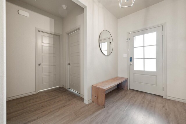 kitchen featuring stainless steel appliances, light stone countertops, sink, and a center island with sink