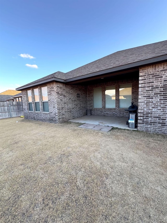 exterior space with a patio area and a lawn