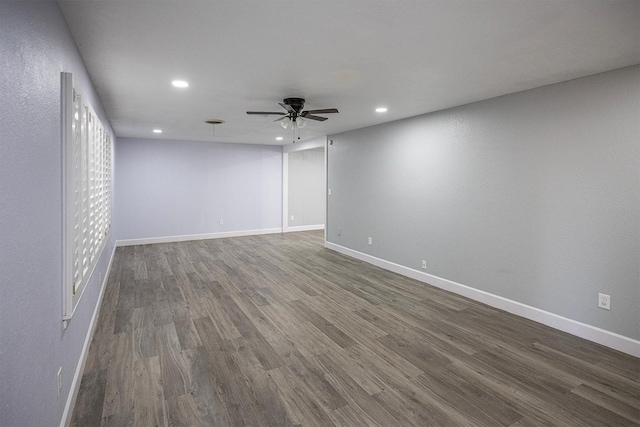 spare room with dark hardwood / wood-style floors and ceiling fan