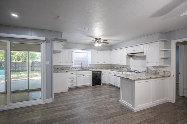 kitchen featuring black dishwasher, sink, white cabinets, light stone counters, and kitchen peninsula