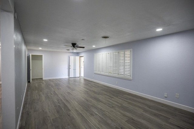 unfurnished room featuring dark wood-type flooring and ceiling fan