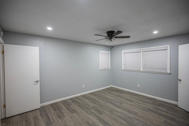 unfurnished room with dark hardwood / wood-style flooring and ceiling fan