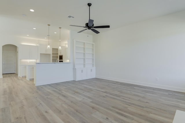 unfurnished living room with ceiling fan and light hardwood / wood-style flooring