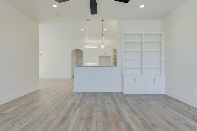 unfurnished living room featuring light hardwood / wood-style floors and ceiling fan