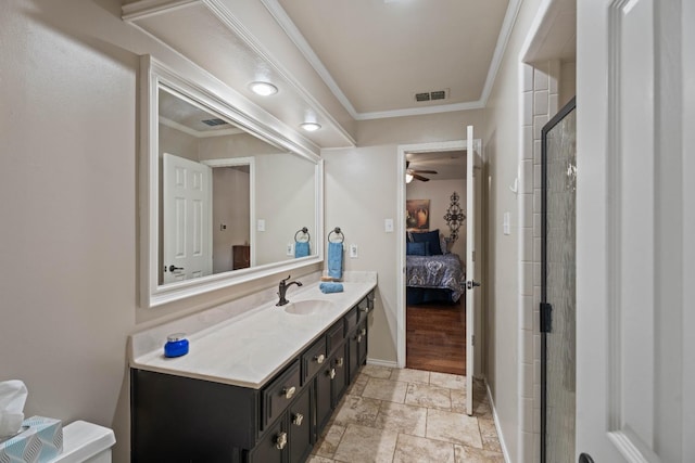 bathroom with vanity, walk in shower, ceiling fan, toilet, and crown molding