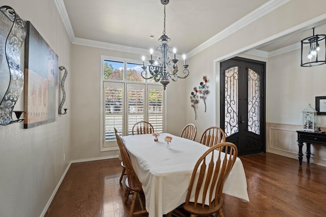 dining room featuring french doors, ornamental molding, dark hardwood / wood-style floors, and a chandelier