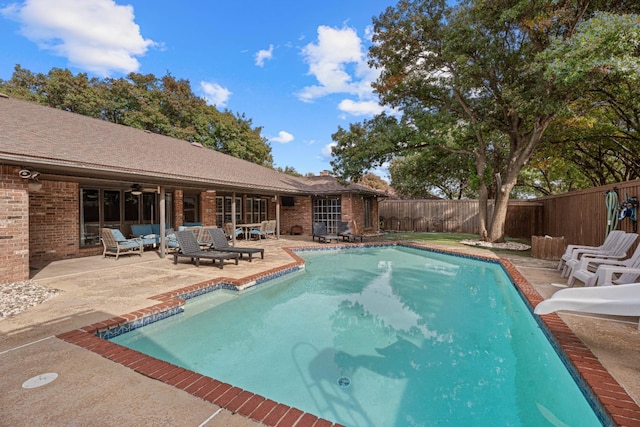 view of pool featuring an outdoor living space and a patio area