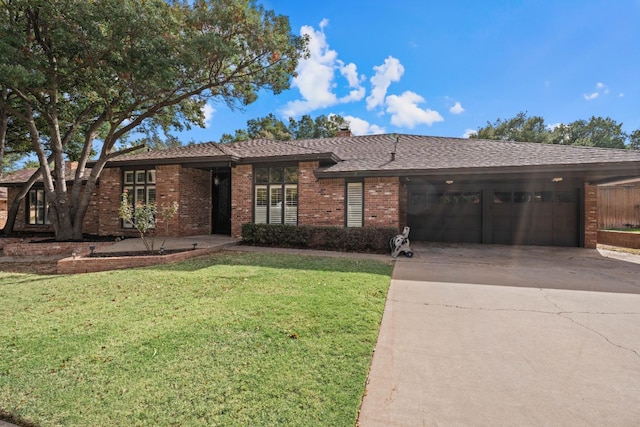 ranch-style home with a garage and a front yard