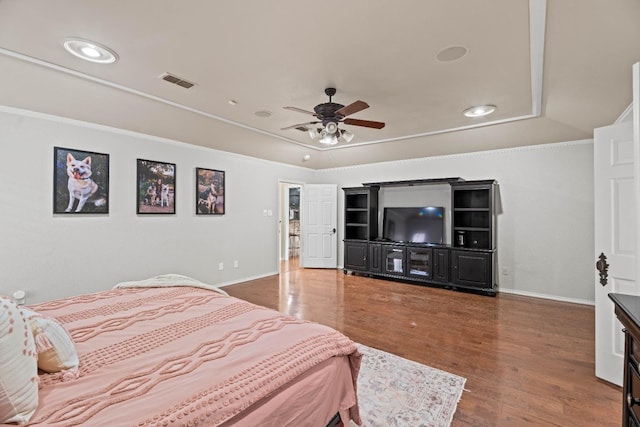 bedroom with hardwood / wood-style flooring, ornamental molding, and ceiling fan