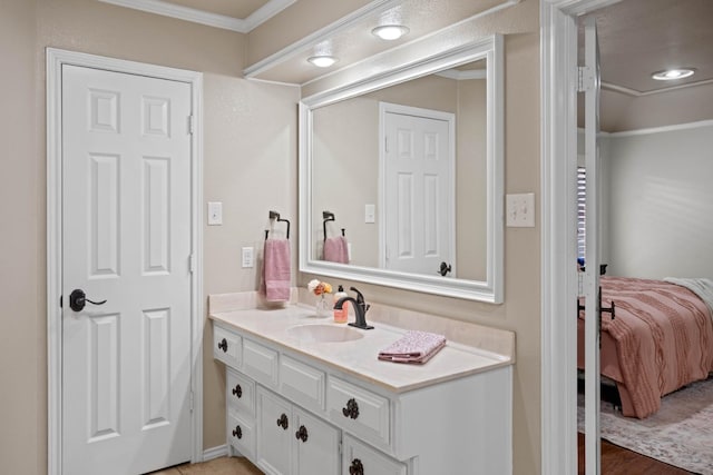 bathroom with vanity and ornamental molding