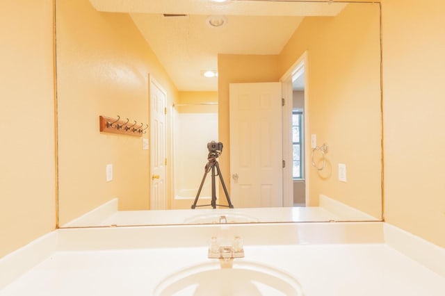 bathroom with vanity and a textured ceiling