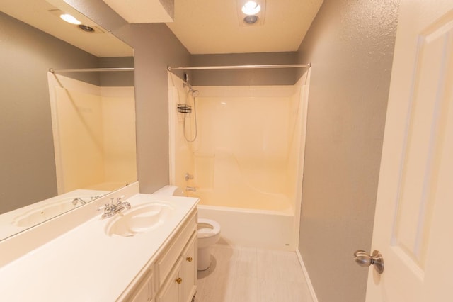 full bathroom featuring vanity, bathtub / shower combination, and toilet