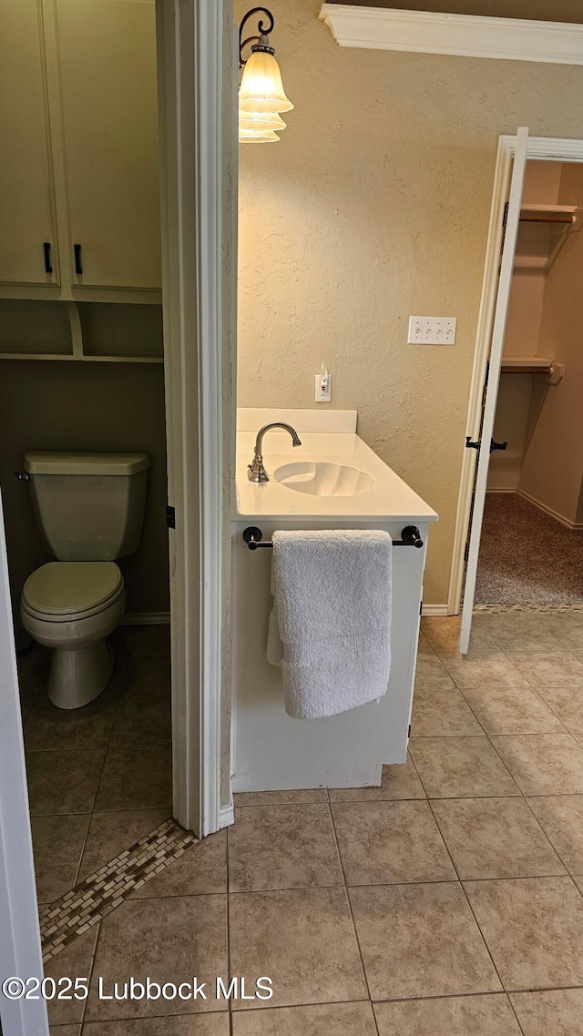 1 Squaw Ln, Ransom Canyon, TX 79366 - bathroom with tile patterned floors, vanity, and a walk in closet