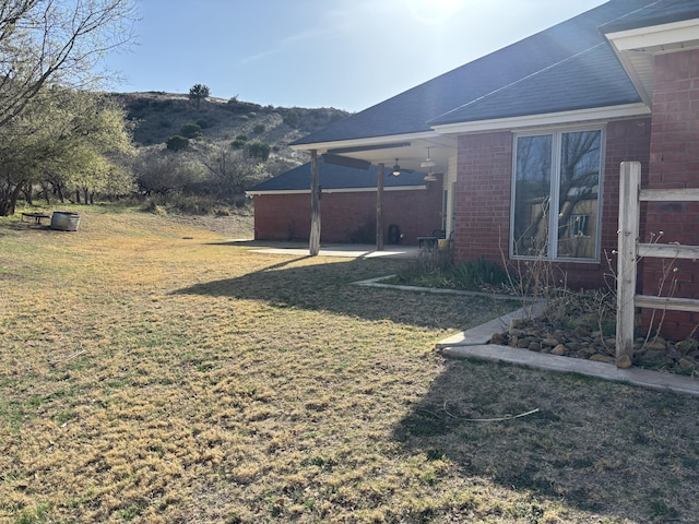 1 Squaw Ln, Ransom Canyon, TX 79366 - view of green lawn with a patio area and a mountain view