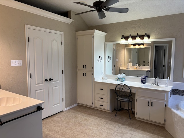 1 Squaw Ln, Ransom Canyon, TX 79366 - bathroom with vanity, lofted ceiling, a bath, ceiling fan, and a textured wall