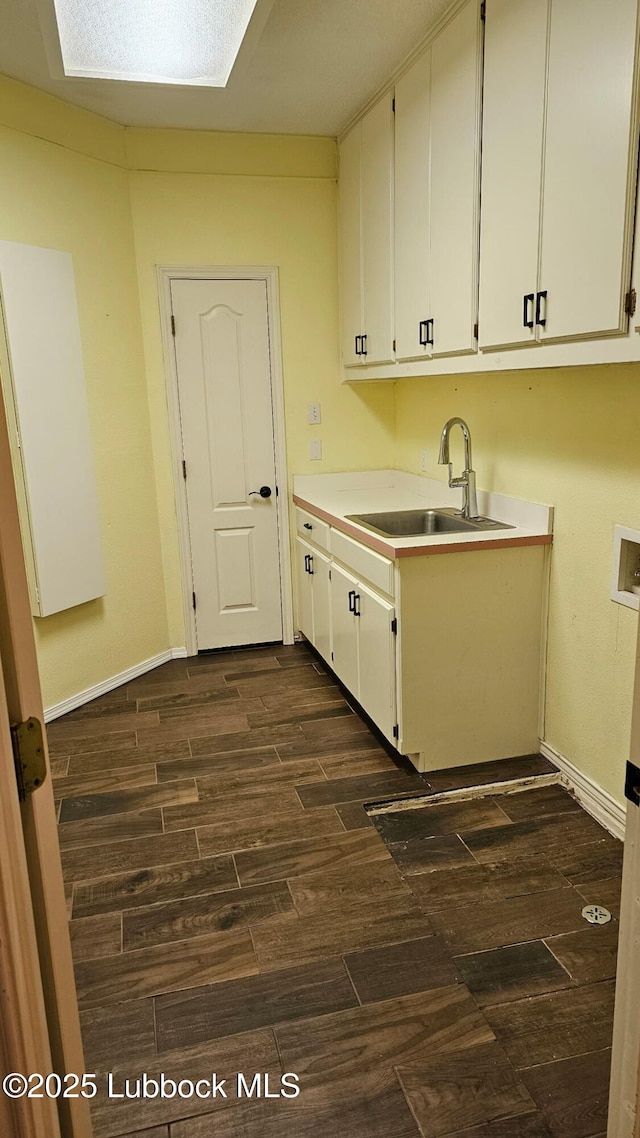 1 Squaw Ln, Ransom Canyon, TX 79366 - laundry room with cabinet space, dark wood-type flooring, and washer hookup