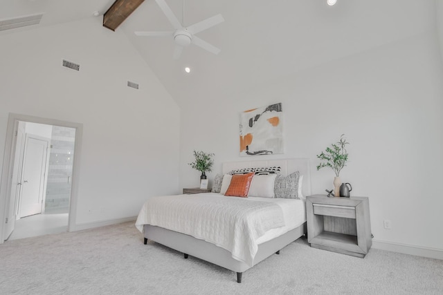 carpeted bedroom featuring beam ceiling, ensuite bathroom, high vaulted ceiling, and ceiling fan