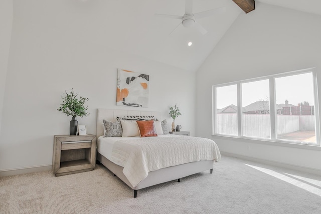 carpeted bedroom featuring beamed ceiling, high vaulted ceiling, and ceiling fan