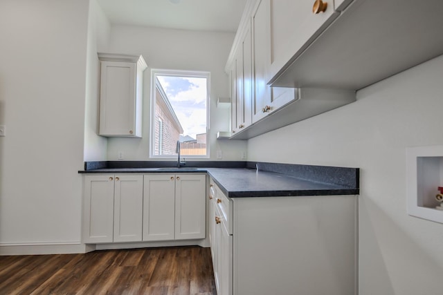 kitchen featuring sink, dark wood-type flooring, and white cabinets