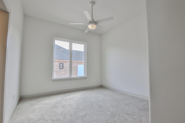 spare room featuring ceiling fan and light colored carpet