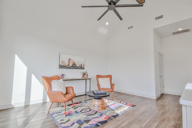 sitting room featuring ceiling fan, high vaulted ceiling, and light hardwood / wood-style flooring