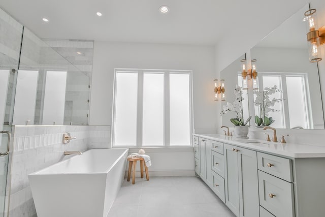 bathroom featuring vanity, tile patterned flooring, and separate shower and tub