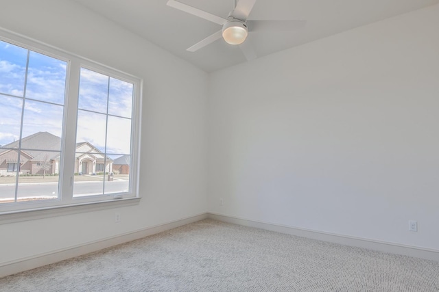 spare room with carpet flooring and ceiling fan