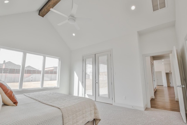 carpeted bedroom featuring multiple windows, beamed ceiling, high vaulted ceiling, and ceiling fan