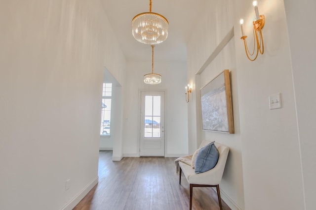 doorway with hardwood / wood-style flooring and a chandelier