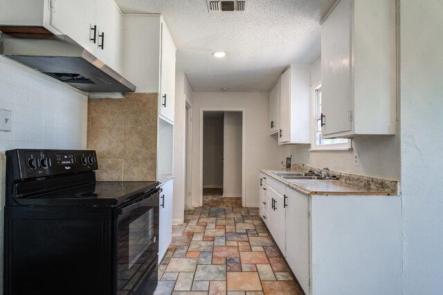 kitchen with black electric range oven, sink, white cabinets, and decorative backsplash