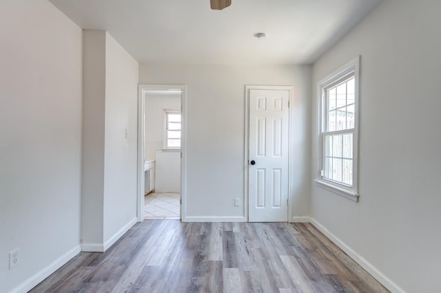 unfurnished bedroom featuring light hardwood / wood-style flooring and a closet