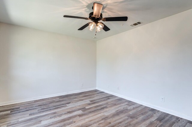 spare room featuring ceiling fan and light hardwood / wood-style flooring