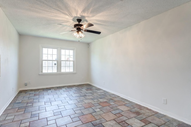 empty room featuring ceiling fan and a textured ceiling