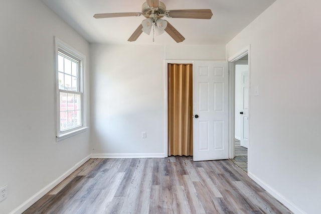 spare room featuring ceiling fan and light wood-type flooring