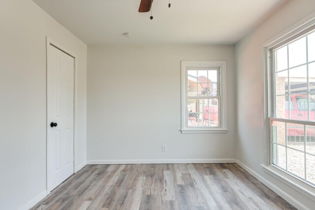 empty room featuring ceiling fan and light hardwood / wood-style flooring