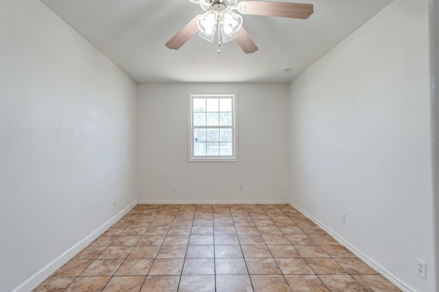 unfurnished room with ceiling fan and light tile patterned floors