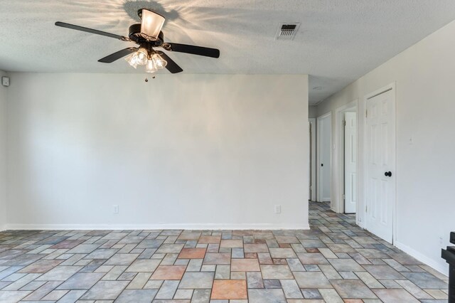 spare room with ceiling fan and a textured ceiling