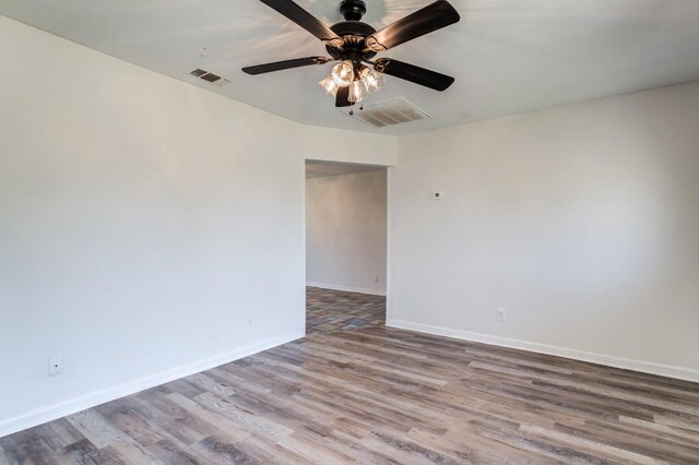 empty room with ceiling fan and light hardwood / wood-style flooring