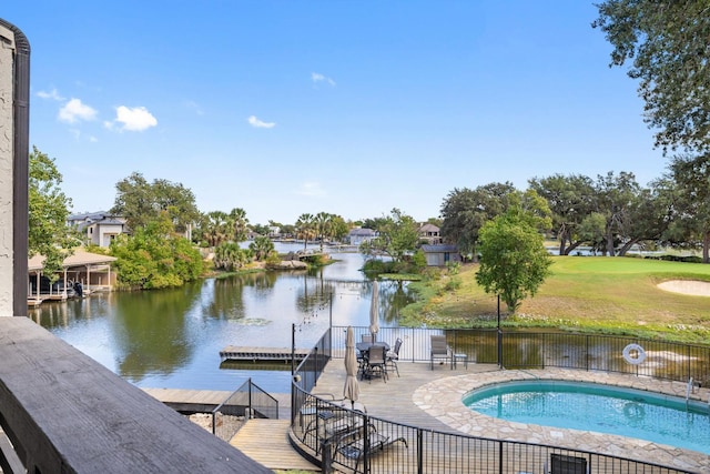 view of swimming pool featuring a boat dock and a water view