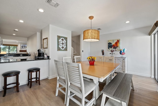 dining space with light hardwood / wood-style floors