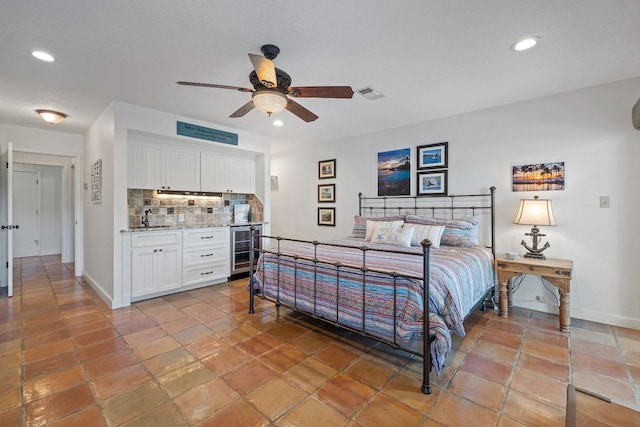 bedroom with sink, wine cooler, and ceiling fan