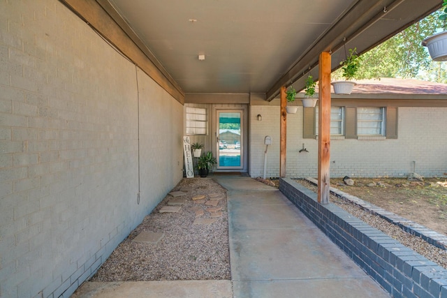 doorway to property with brick siding