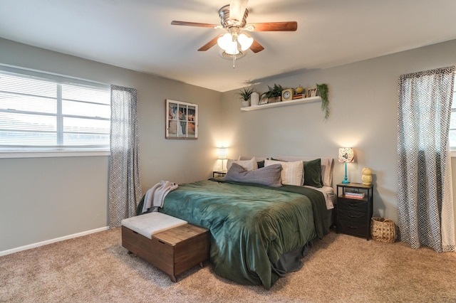 bedroom featuring a ceiling fan, light carpet, and baseboards