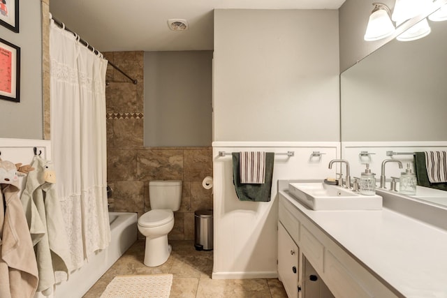 full bath featuring tile walls, vanity, toilet, visible vents, and tile patterned flooring